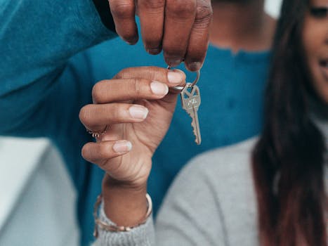 A couple holding a key, symbolizing a new home ownership or rental.